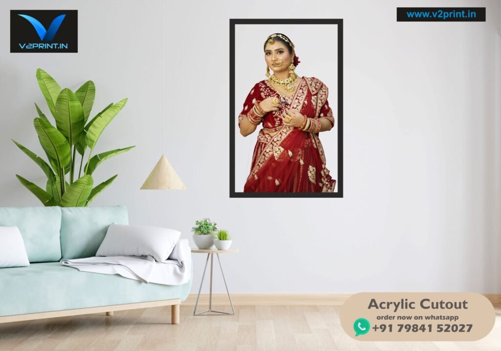 Framed acrylic photo print of a woman in a red outfit on a living room wall with a sofa and plant nearby.
